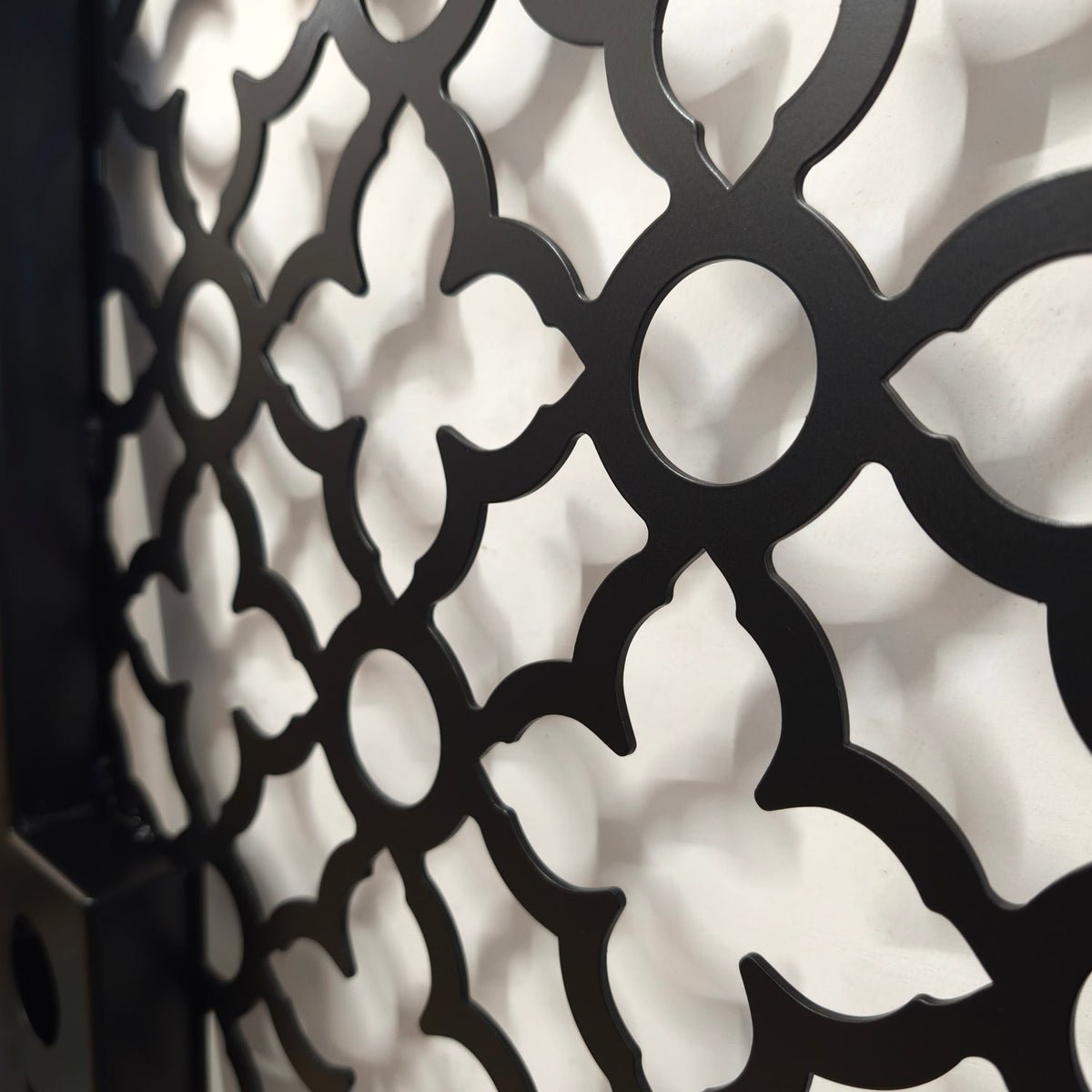 Close-up of the Casablanca Moroccan quatrefoil laser cut pattern with smooth powder coated edges on a black steel gate
