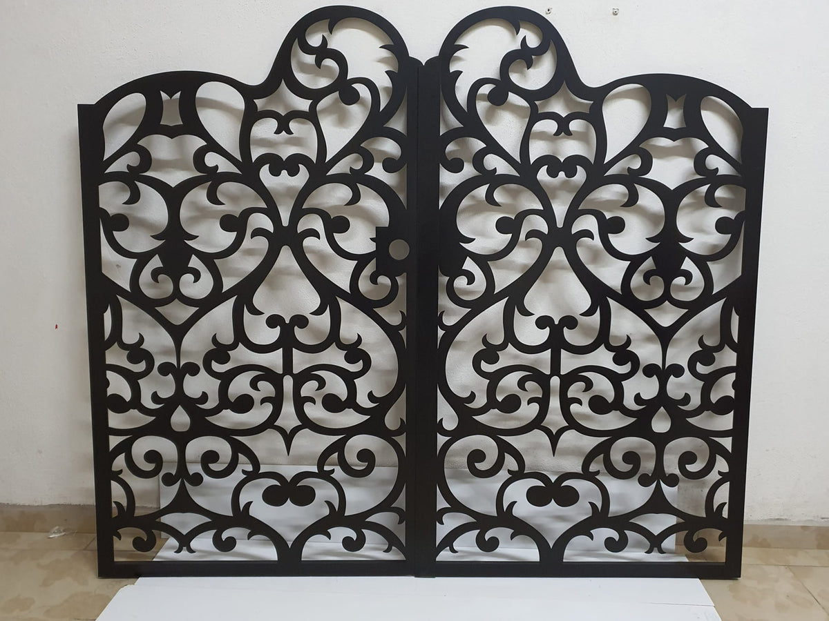 Black powder coated laser cut metal double driveway gate featuring ornate damask arabesque  pattern installed between natural stone pillars