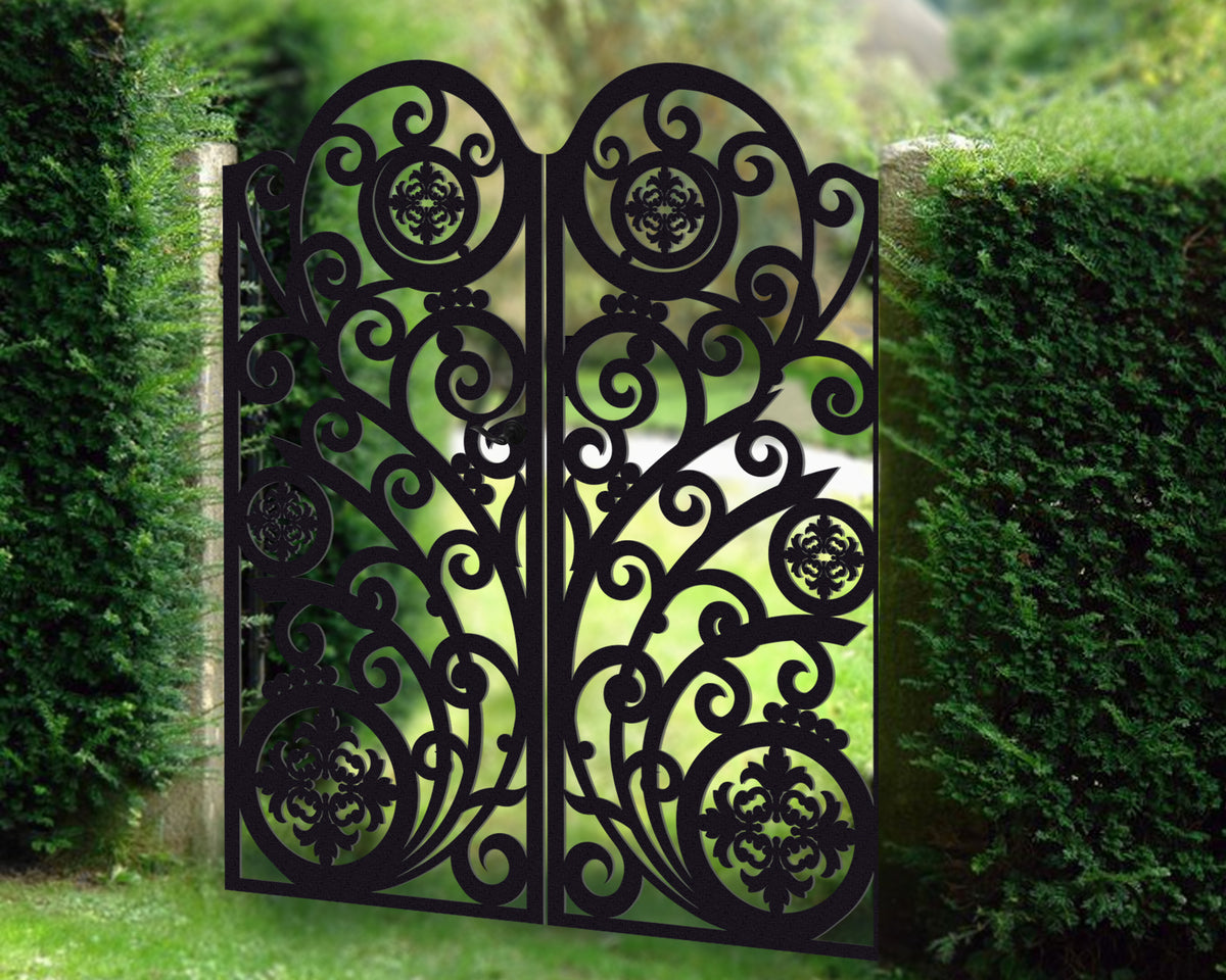 Black powder coated laser cut metal double driveway gate featuring ornate scrollwork pattern with circular floral medallions installed in garden setting