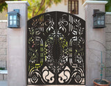 Black powder coated laser cut metal double pedestrian gate featuring arched top frame with ornate floral damask pattern installed between concrete pillars