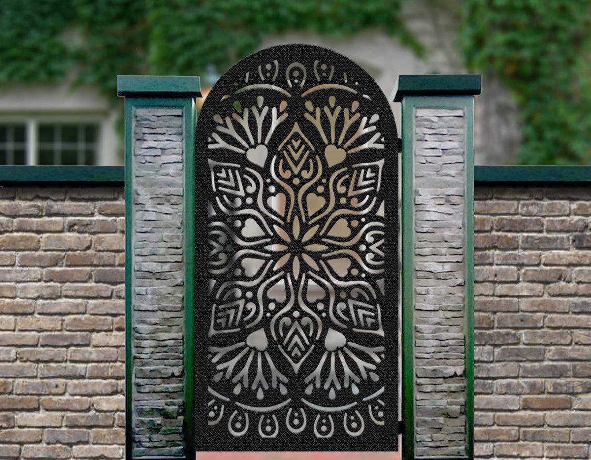 Black powder coated laser cut metal pedestrian garden gate featuring arched top with ornate mandala floral medallion pattern installed between pillars