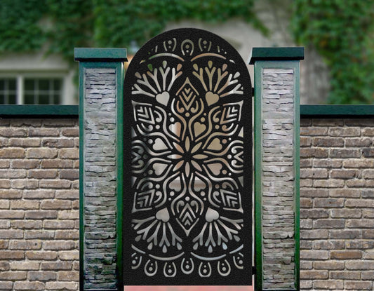 Black powder coated laser cut metal pedestrian garden gate featuring arched top with ornate mandala floral medallion pattern installed between pillars