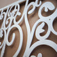 Matte white powder coated laser cut metal fireplace screen panel featuring traditional wrought iron scrollwork and ornate bar pattern