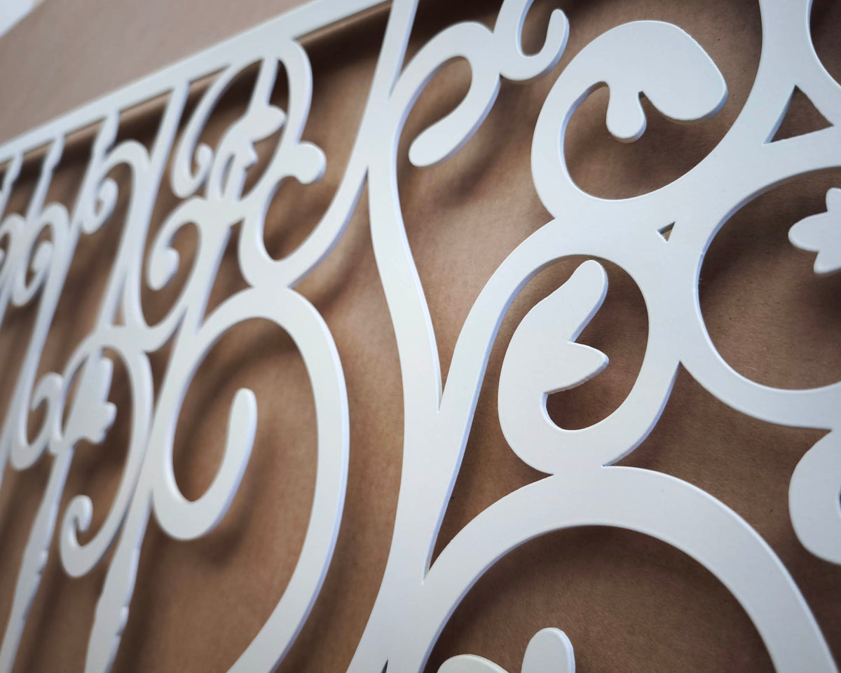 Matte white powder coated laser cut metal fireplace screen panel featuring traditional wrought iron scrollwork and ornate bar pattern