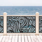 Black decorative laser cut metal deck railing insert panel with modern abstract swirl ocean wave pattern