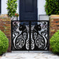 Black powder coated laser cut metal double pedestrian gate featuring ornate cat silhouette pattern installed between brick pillars