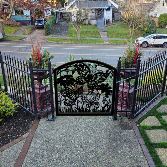Metal laser cut entry garden gate featuring curved arched top frame with butterflies and botanical wildflower pattern