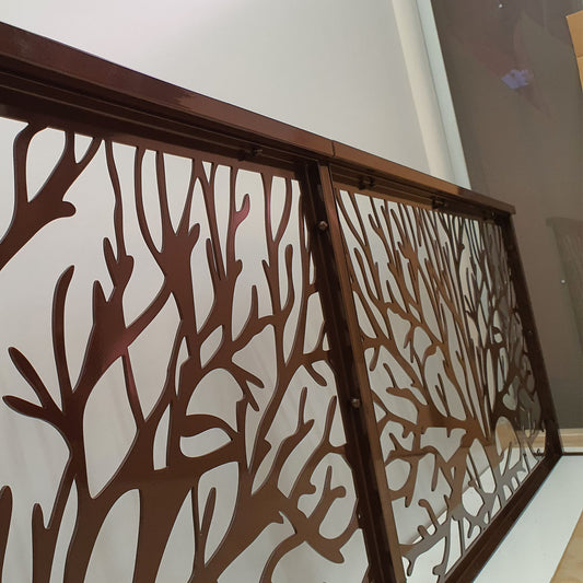 Dark brown metal laser cut fence railing panel featuring organic tree branch and coral silhouette pattern