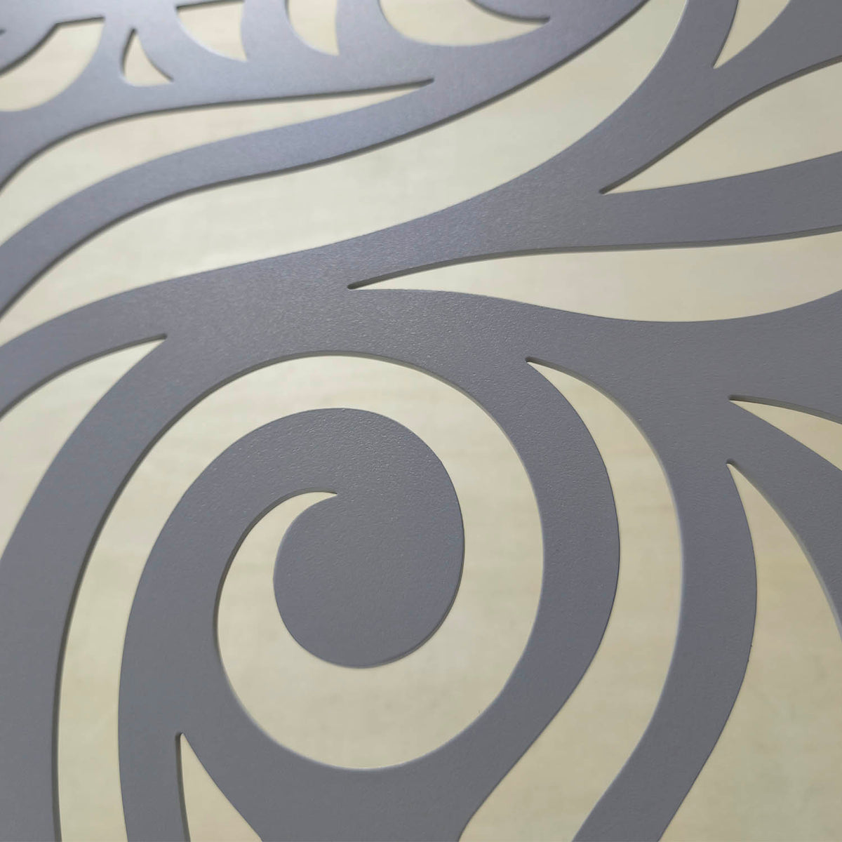 Freestanding matte grey metal fireplace screen with modern decorative laser cut wave pattern