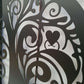 Metal garden gate featuring ornate cat silhouette pattern installed between brick pillars