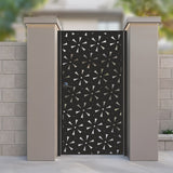 Black metal laser cut pedestrian garden gate featuring modern stylized daisy floral and starburst pattern