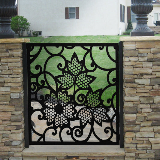 Black decorative laser cut metal garden gate featuring floral leaf pattern with honeycomb texture details