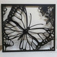 Laser cut metal garden gate featuring large monarch butterfly wing and flower pattern
