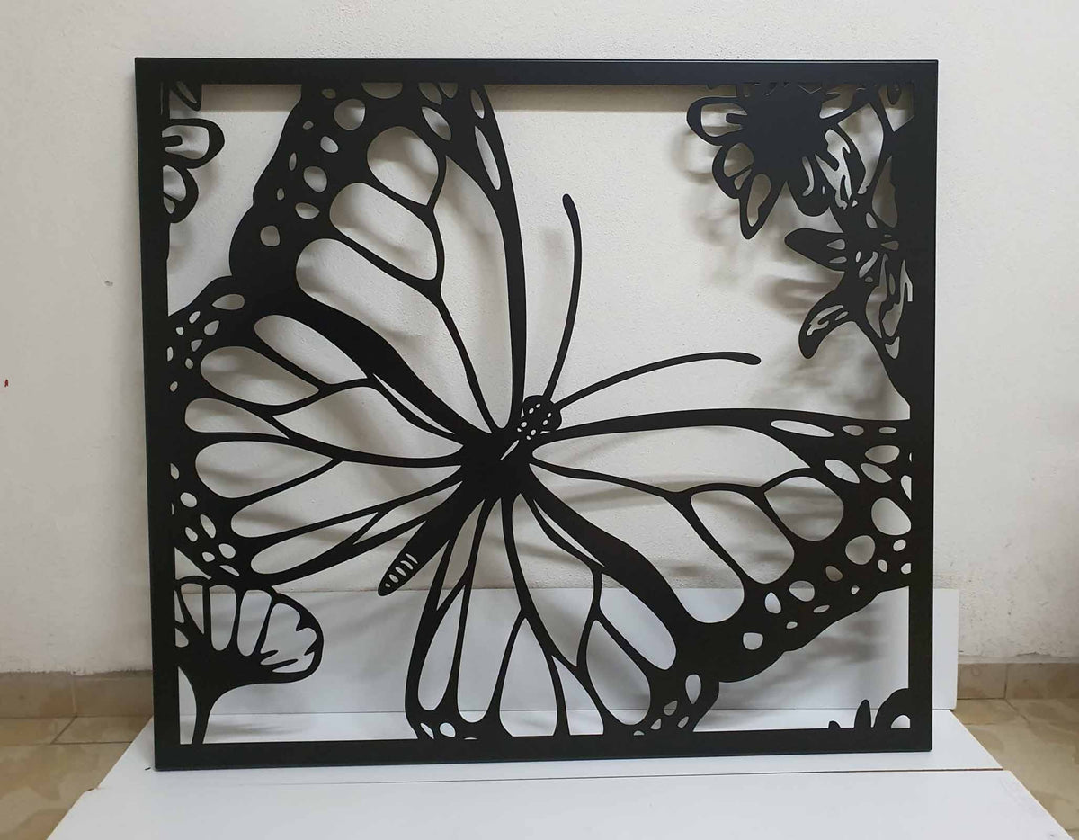 Laser cut metal garden gate featuring large monarch butterfly wing and flower pattern