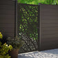 Matte black powder coated laser cut metal pedestrian garden gate featuring abstract pebble cell pattern installed with composite fence panels