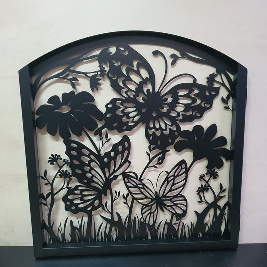 Matte black metal laser cut pedestrian garden gate featuring curved arched top frame with butterflies and botanical wildflower pattern