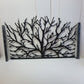 Black metal laser cut pedestrian garden gate featuring organic tree branch pattern with scalloped top edge and post