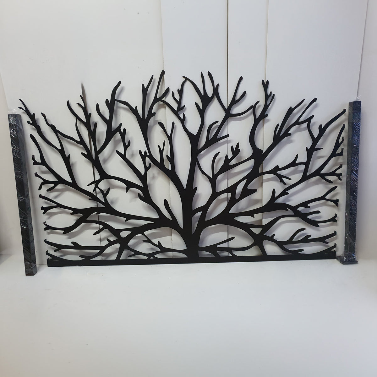 Black metal laser cut pedestrian garden gate featuring organic tree branch pattern with scalloped top edge and post