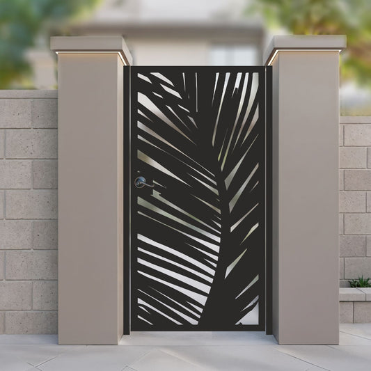 Black metal laser cut pedestrian garden gate featuring modern tropical palm frond leaf silhouette design