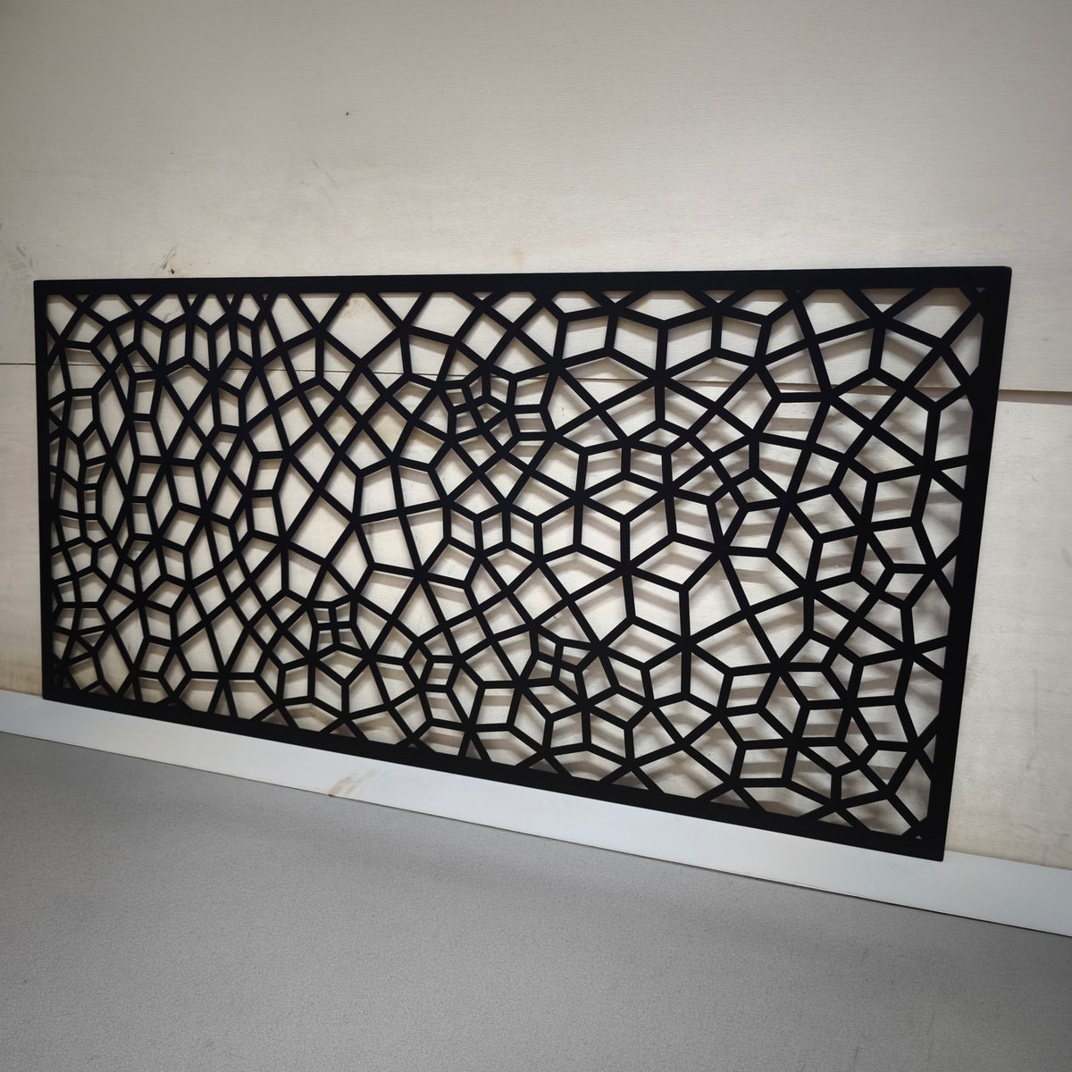 Black decorative web laser cut metal panel with 3D geometric cube illusion and voronoi polygon pattern