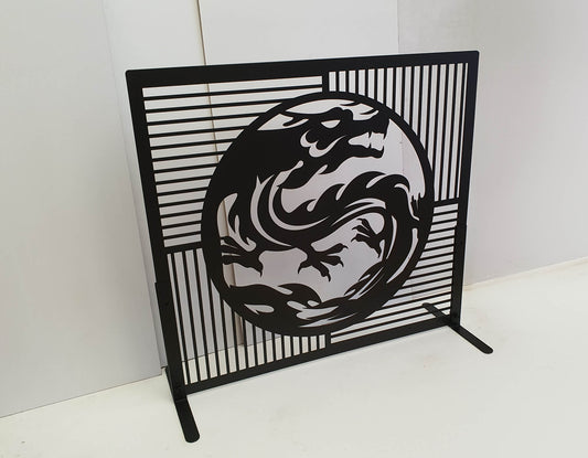Matte black powder coated laser cut metal freestanding fireplace screen featuring central circular dragon medallion with geometric slatted grid background