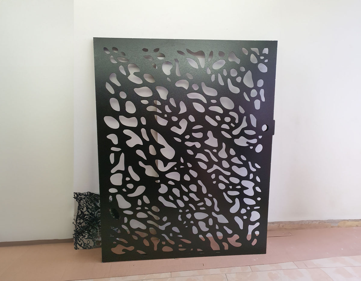 Matte black powder coated laser cut metal pedestrian garden gate featuring abstract pebble cell pattern installed with composite fence panels