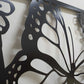 Black powder coated laser cut metal side pedestrian gate featuring large monarch butterfly wing detail