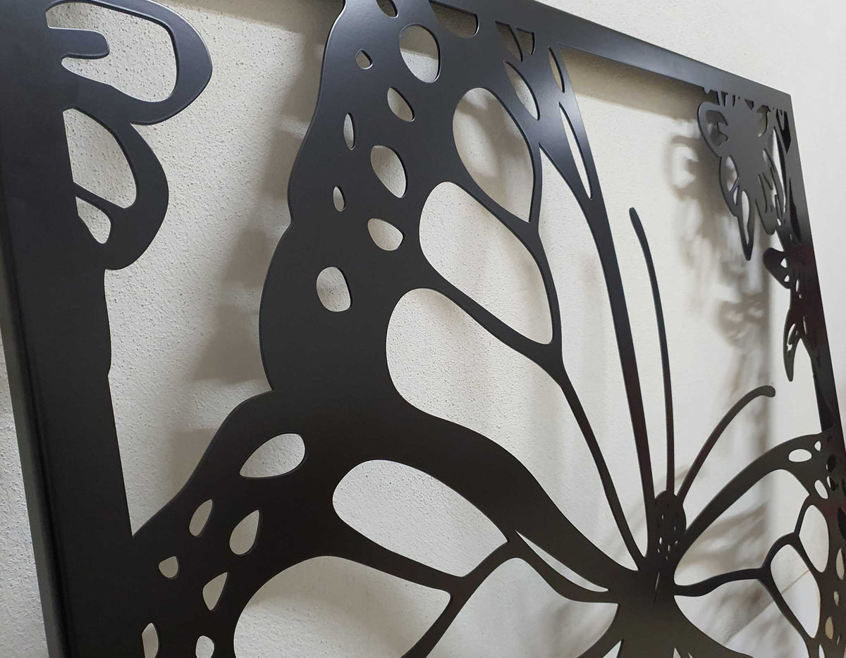 Black powder coated laser cut metal side pedestrian gate featuring large monarch butterfly wing detail