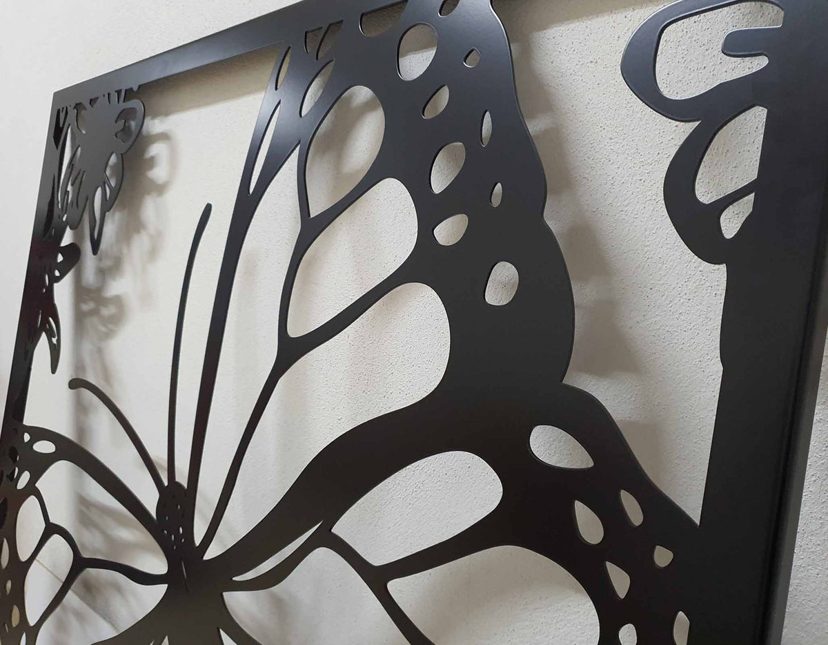 Black powder coated laser cut metal garden entrance featuring large monarch butterfly wing detail
