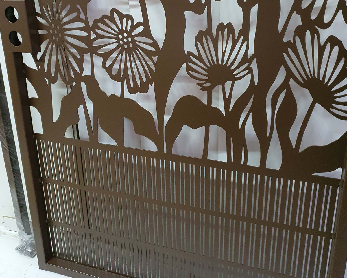 Metal garden gate with arched top frame featuring central daisy flower garden pattern and vertical slatted bars