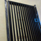 Metal pedestrian garden gate featuring vertical slatted bar pattern and side mounting posts