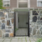Black powder coated modern metal pedestrian garden gate with vertical slatted pattern installed between natural stone walls
