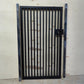 Black powder coated modern metal pedestrian garden gate featuring vertical slatted bar pattern and side mounting posts
