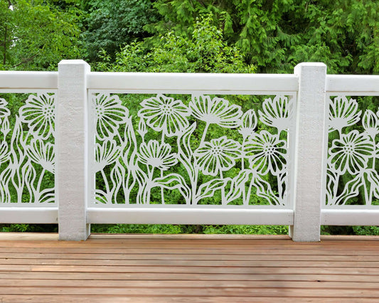 White powder coated laser cut metal balcony railing insert panel featuring daisy floral flower pattern installed on outdoor wooden deck