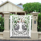 White powder coated laser cut metal double pedestrian gate featuring oval tree of life pattern installed between beige concrete pillars