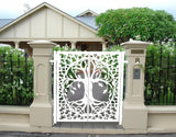 White powder coated laser cut metal double pedestrian gate featuring oval tree of life pattern installed between beige concrete pillars