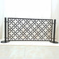 Front view of a black freestanding dog pool fence panel with quatrefoil laser cut pattern mounted between two round base stainless steel posts