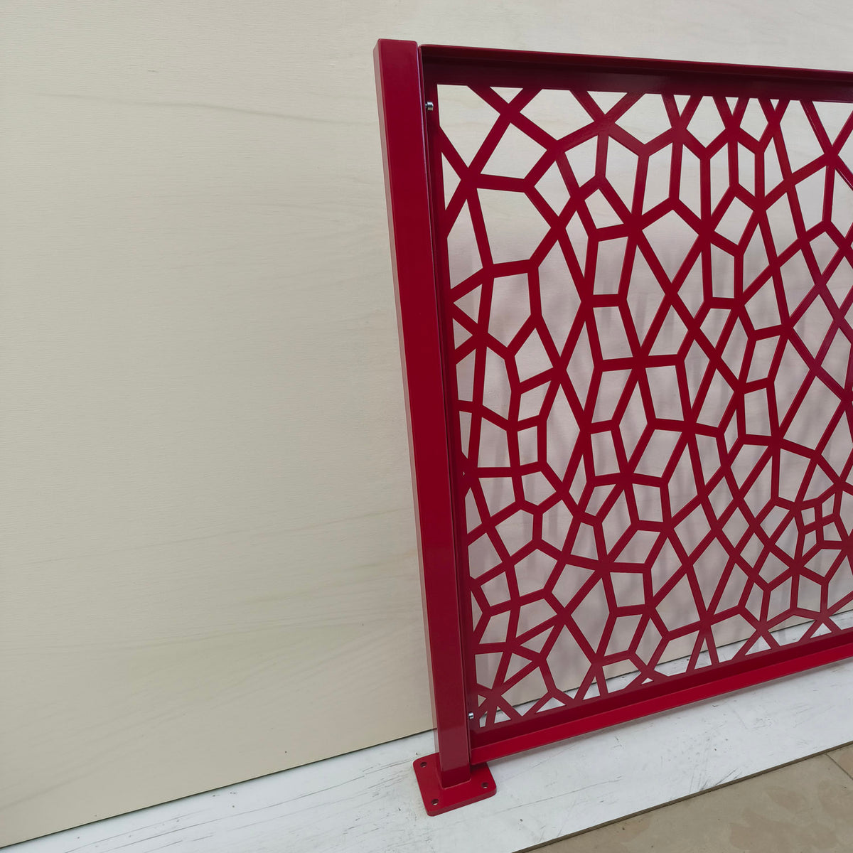 Honeycomb Voronoi laser cut balcony railing panel mounted on a square steel post with surface mount base plate