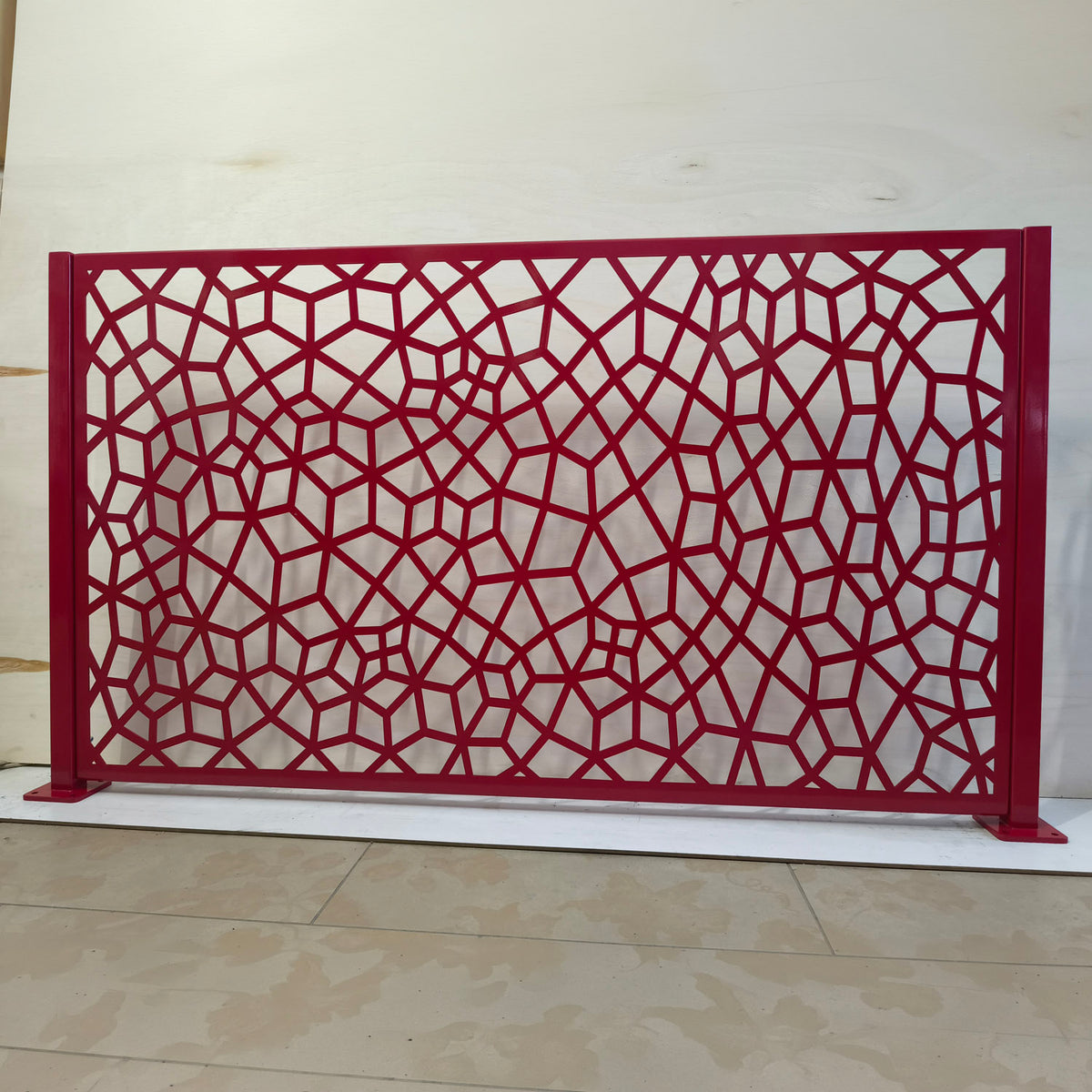 Honeycomb Voronoi laser cut metal railing panel in glossy red powder coat with two steel posts and base plates
