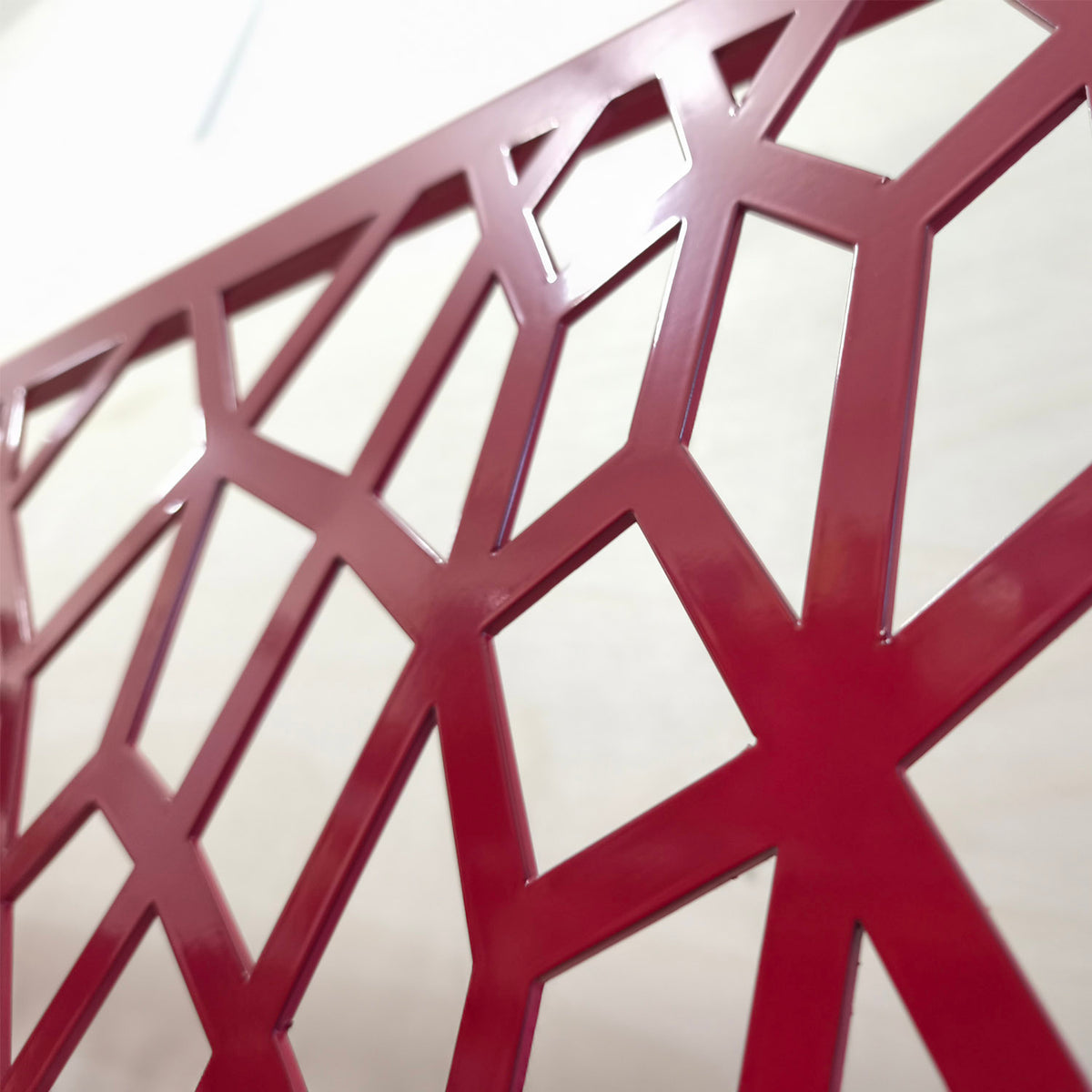 Close-up of the honeycomb Voronoi laser cut cell pattern with smooth glossy powder coated edges
