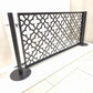 Freestanding no drill dog pool fence panel with two stainless steel round base posts and laser cut moroccan pattern