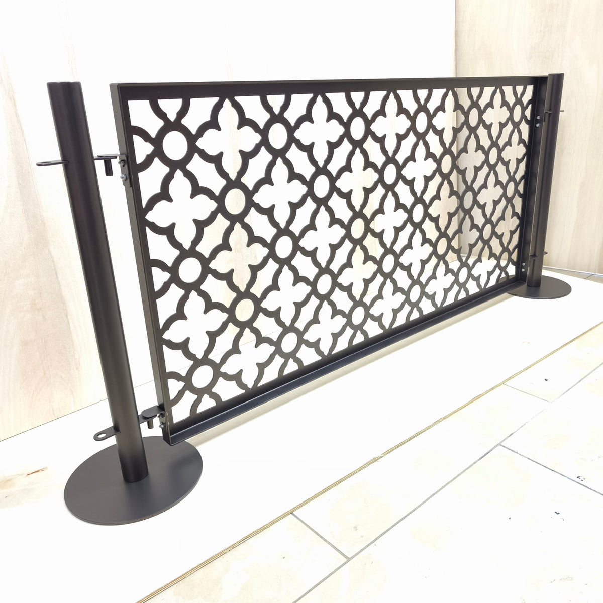 Freestanding no drill dog pool fence panel with two stainless steel round base posts and laser cut moroccan pattern