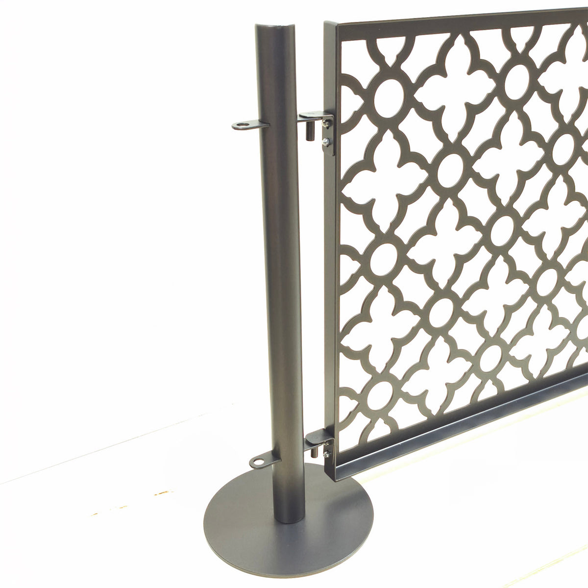 Stainless steel freestanding pool fence post with round base and drop in pin brackets that attach the laser cut panel without tools