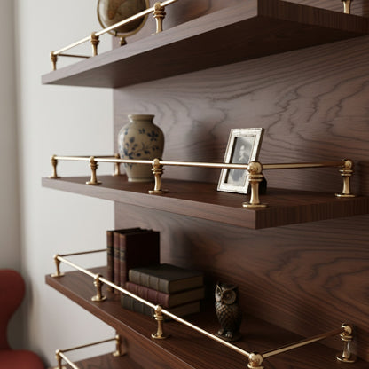 Solid unlacquered brass gallery rail guards mounted on dark walnut wood open floating shelves displaying decor items and books.